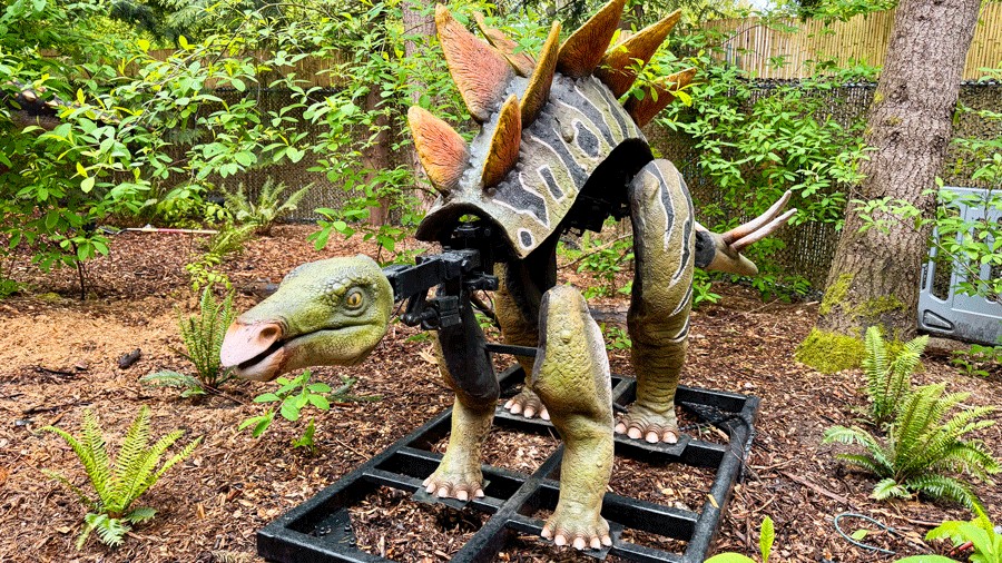 Animatronic Stegosaurus with moving parts, showing the mechanics behind the lifelike dinosaurs at Woodland Park Zoo
