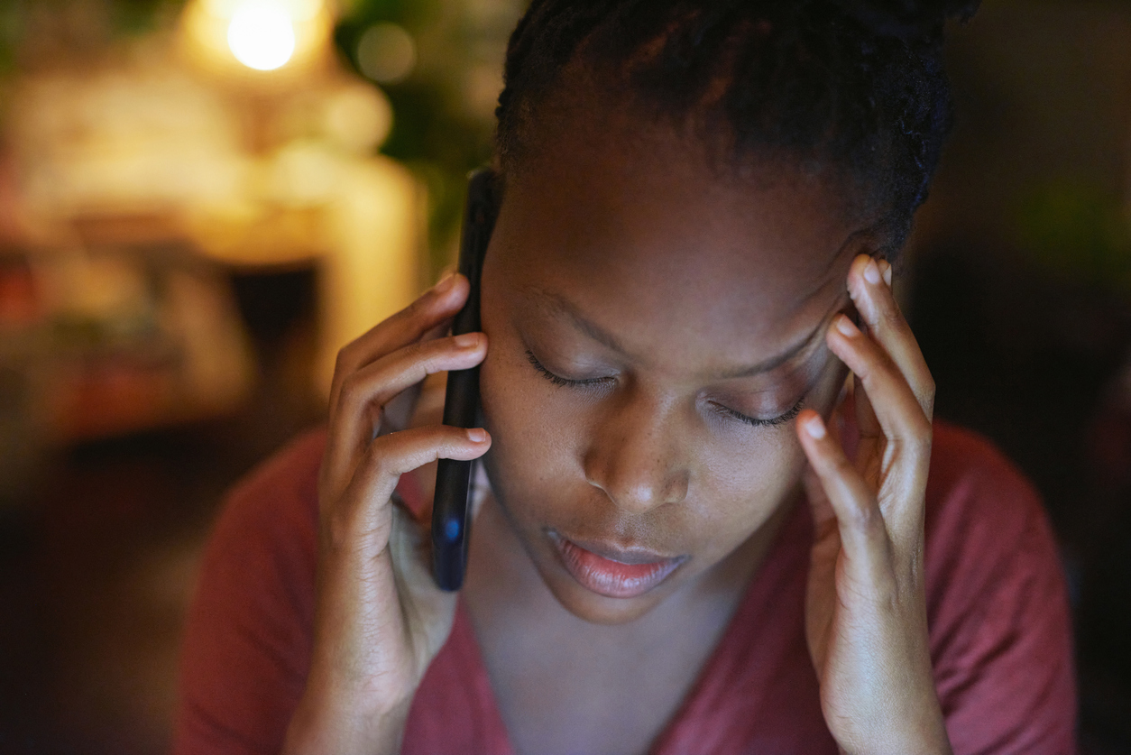 Woman looking sad on the phone