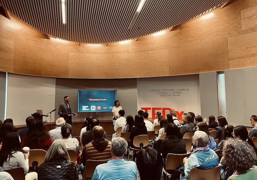 Seatown Story Collective co-founders Jerome Hunter and Kristin Leong deliver opening remarks at TEDxBallardYouth. May 25, 2024. Ballard branch, Seattle Public Library. Photo: Keri Zierler