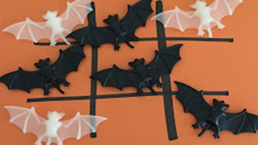 tic tac toe using black and white bats on an orange paper is a halloween game for kids