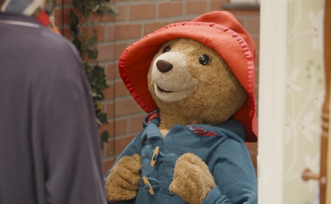 A puppet of Paddington Bear on stage at Seattle Children's Theatre's production of "Paddington Saves Christmas" 2022 season holiday show review from ParentMap