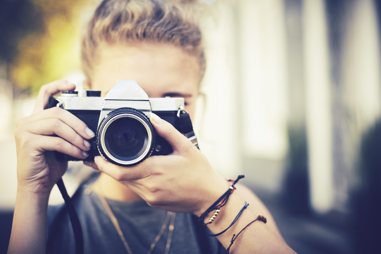 Young boy pointing a camera