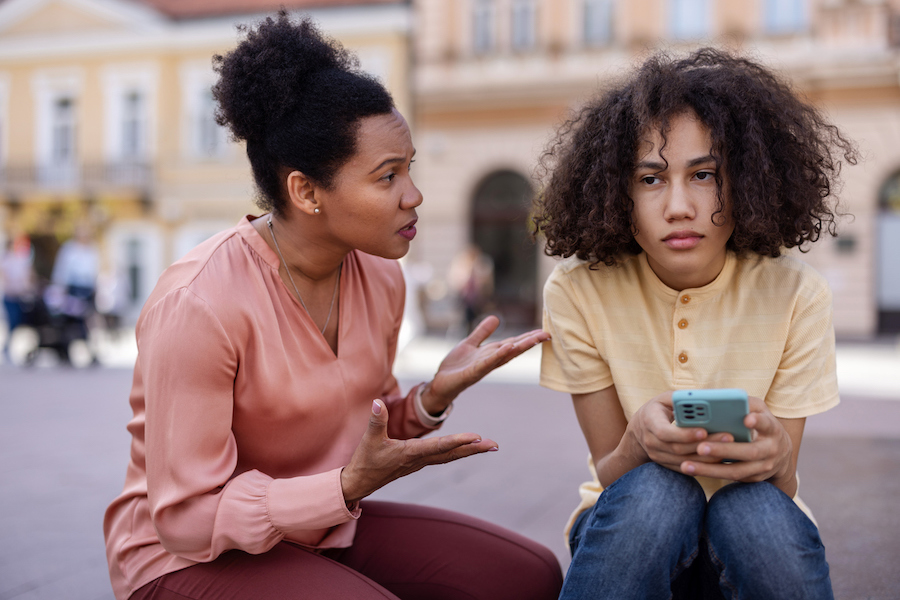 annoyed mom tries to talk to her teenager