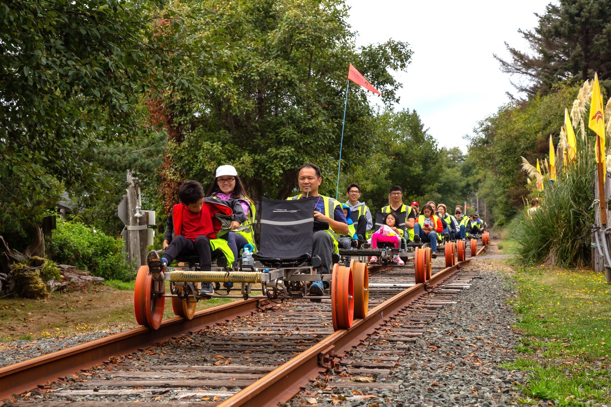 Families ride on rail bikes on an excursion from Oregon's Tillamook Coast, fun destination any time of year