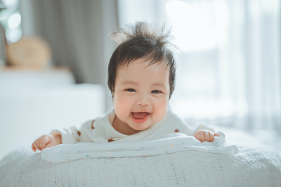 baby on a pillow smiling