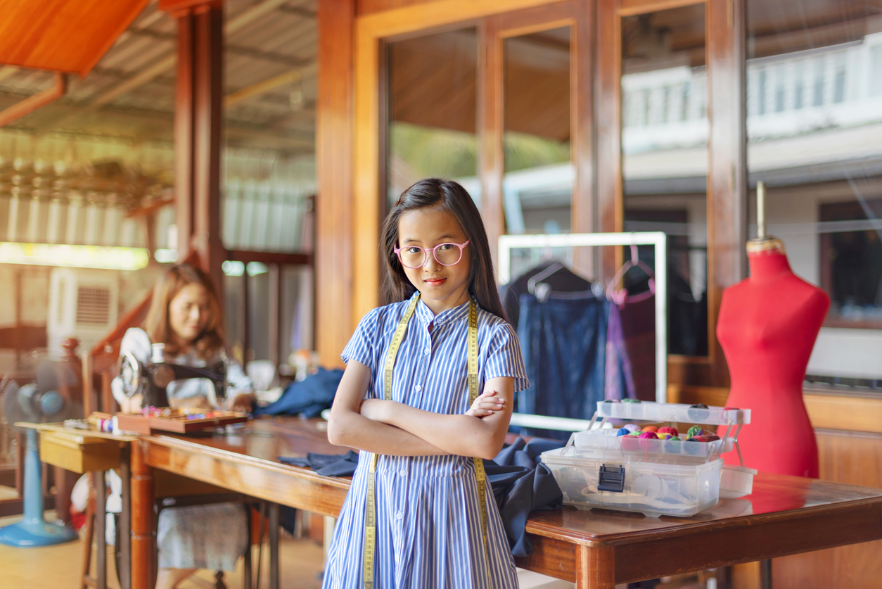 youth entrepreneur standing in front of her business