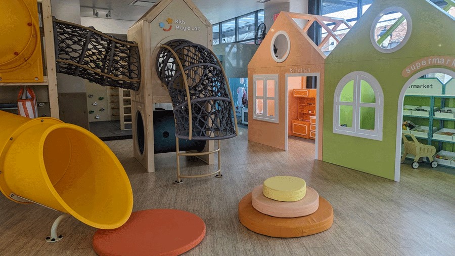 The slide, playhouses and climbing structures at Kids Magic Lab, an indoor playground in Redmond