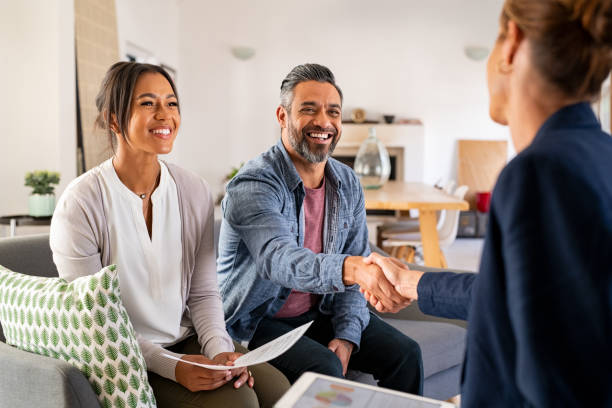 Couple shaking hands with a woman