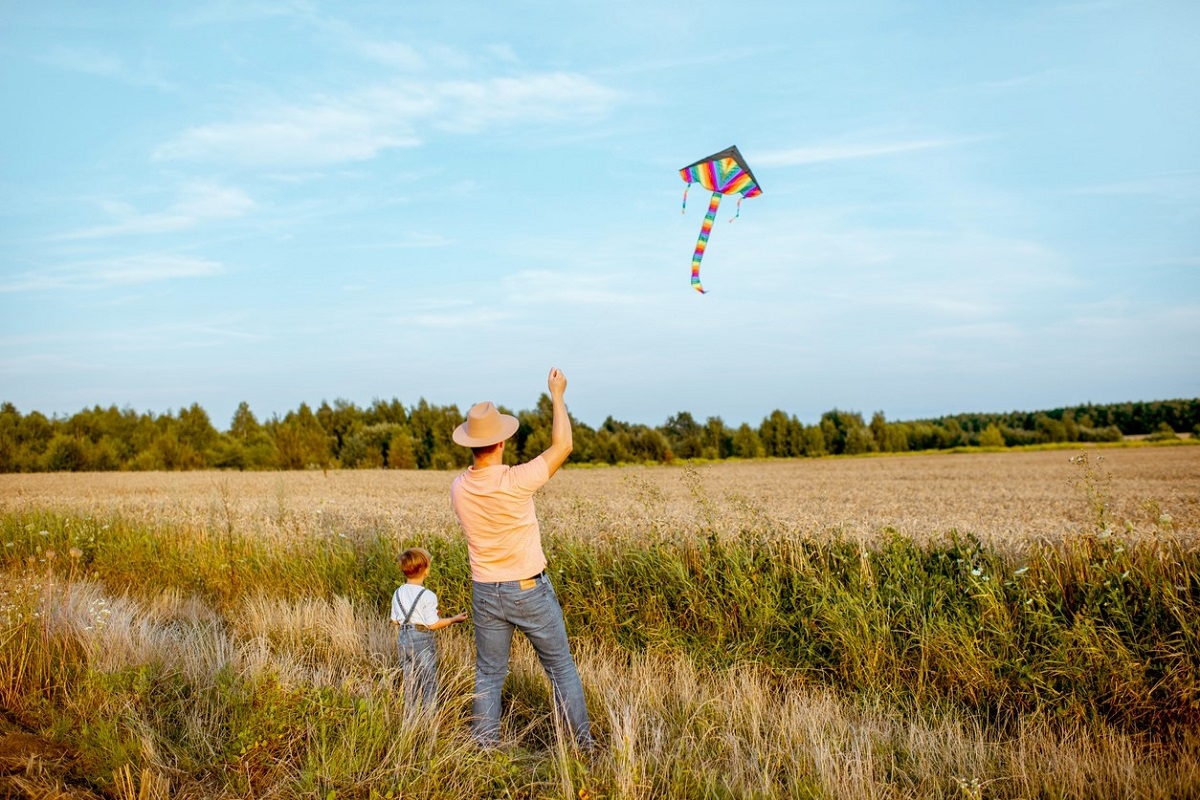 Dad and son flying a kite in a great place to fly a kite near Seattle