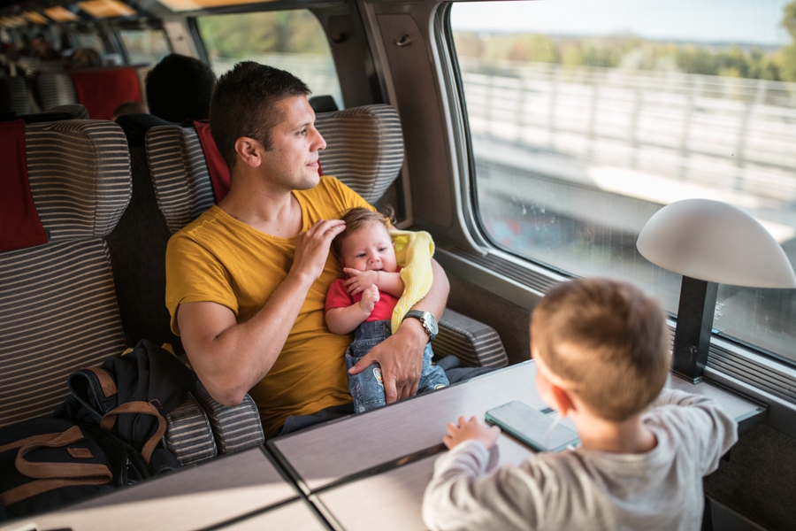 dad on a train with two kids