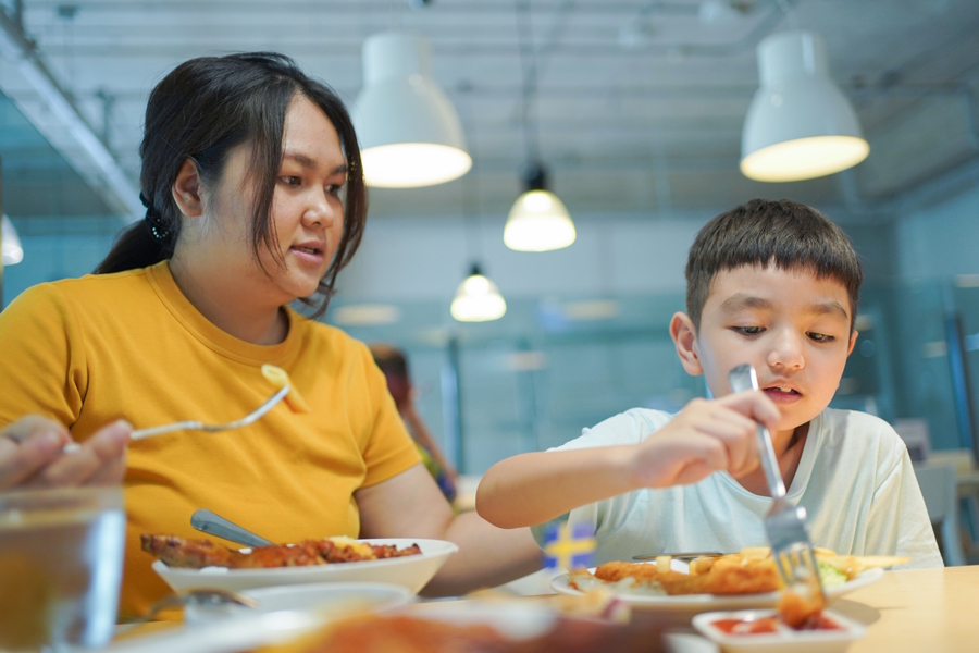 mom and son eating at a restaurant