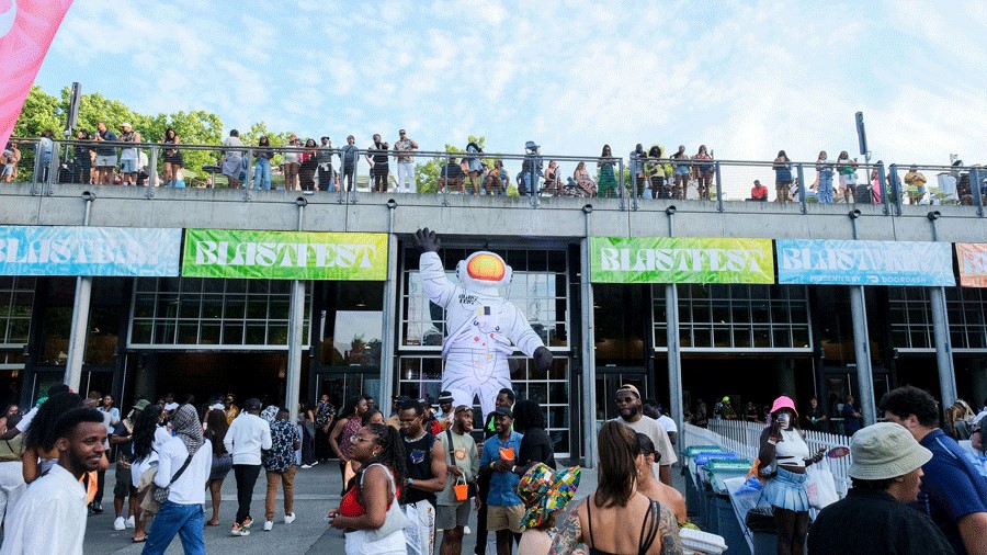 Large astronaut and crowd outside of BLASTFEST, a Seattle Music Festival