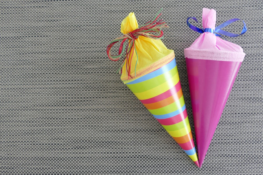 Homemade back-to-school schultuetes, one with stripes and one solid purple