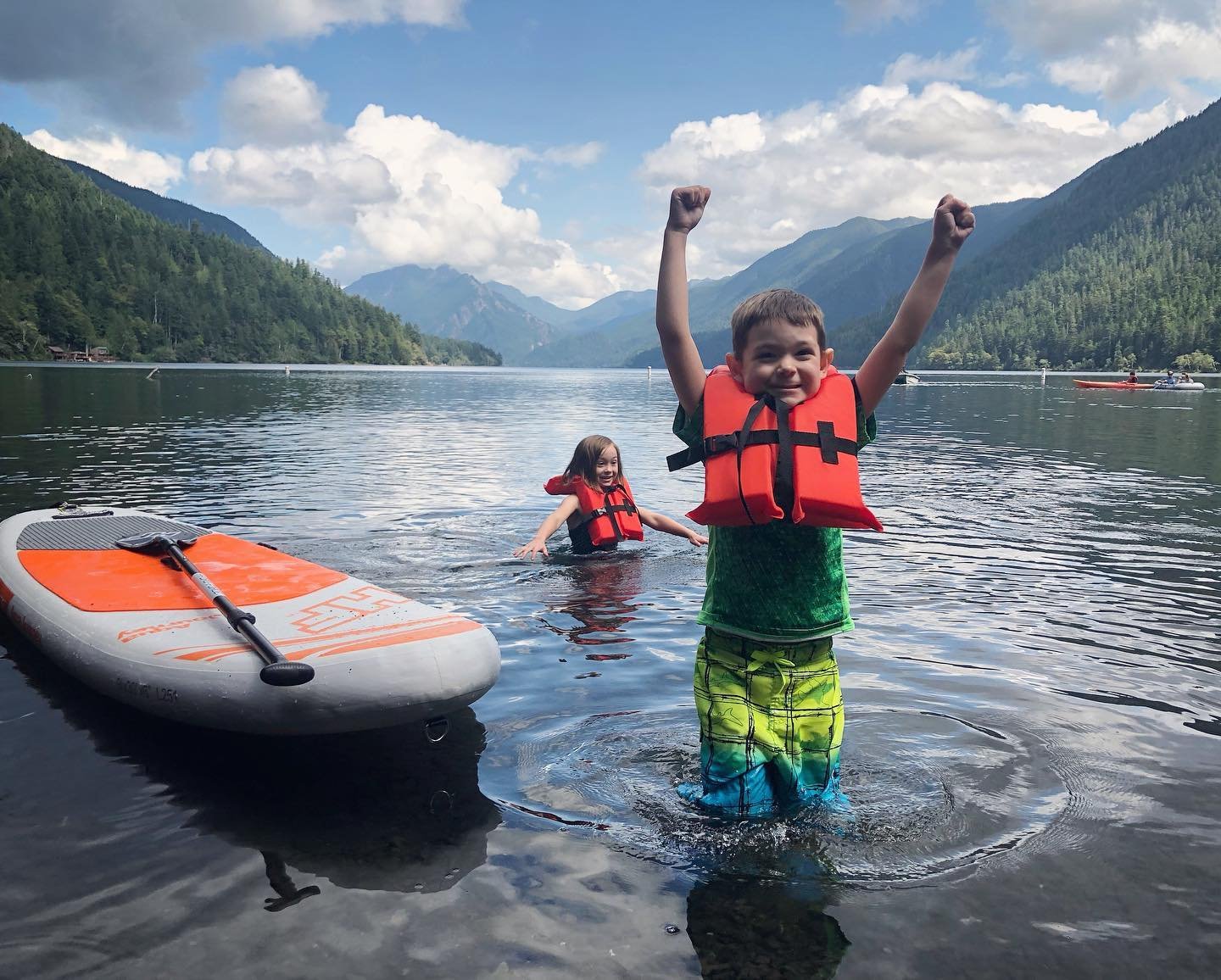 two kids paddleboarding