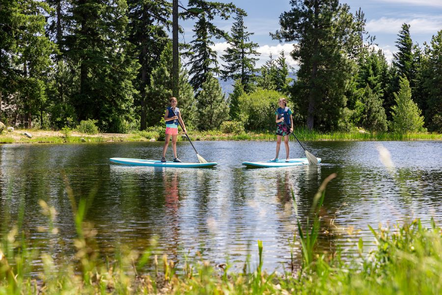boy and girl paddle boarding at Suncadia Resort