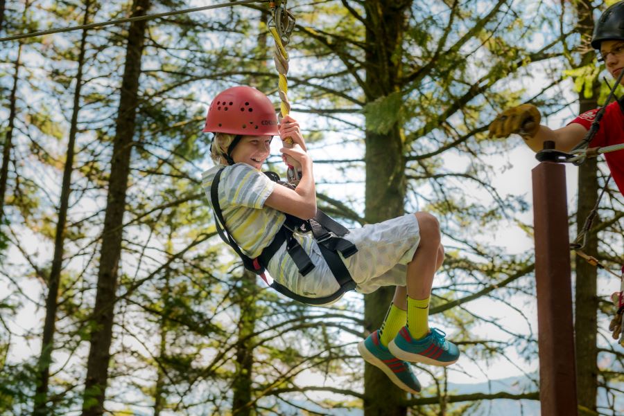 Young blonde boy zip lining at Skamania Lodge