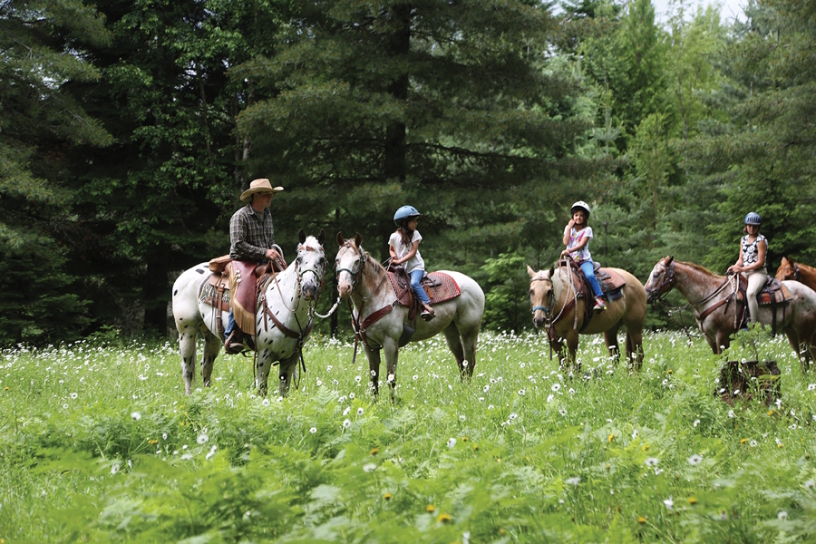 people riding horses at Western Pleasure Guest Ranch