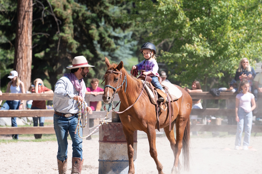 child riding a horse at Flathead Lake Lodge