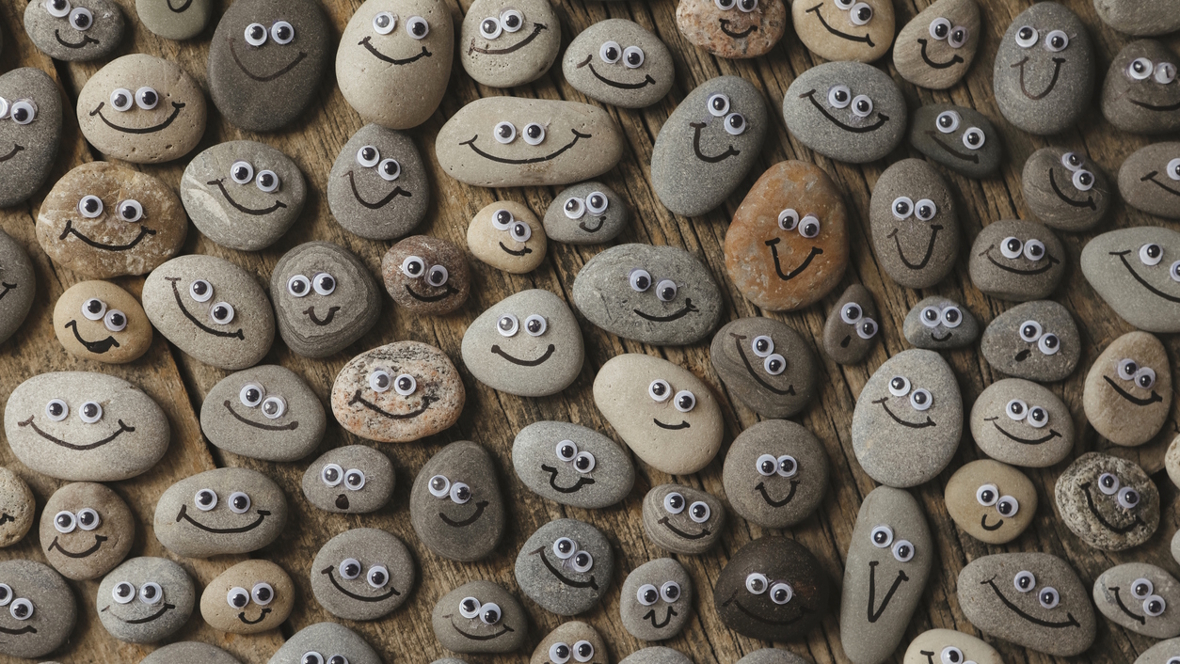 pile of rocks with googly eyes and smiles drawn on