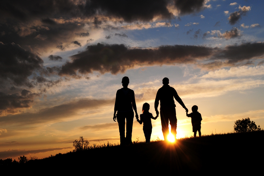 family walking at sunset