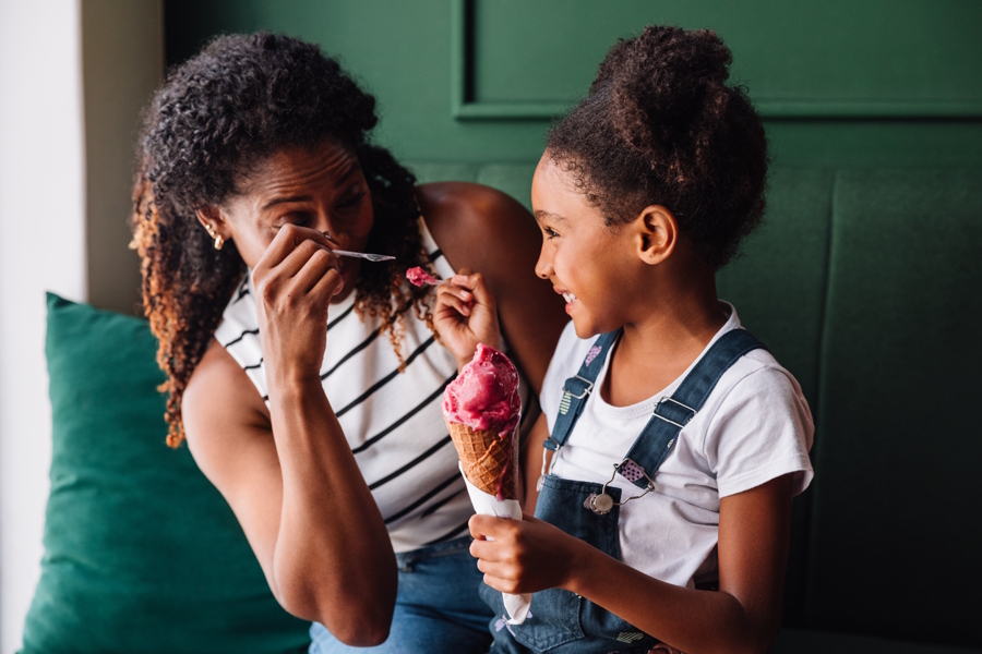 mom and daughter eating ice cream in the summer at night