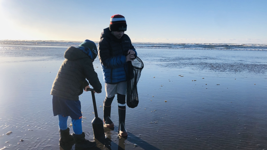 Two boys on the beach clamming Washington clamming