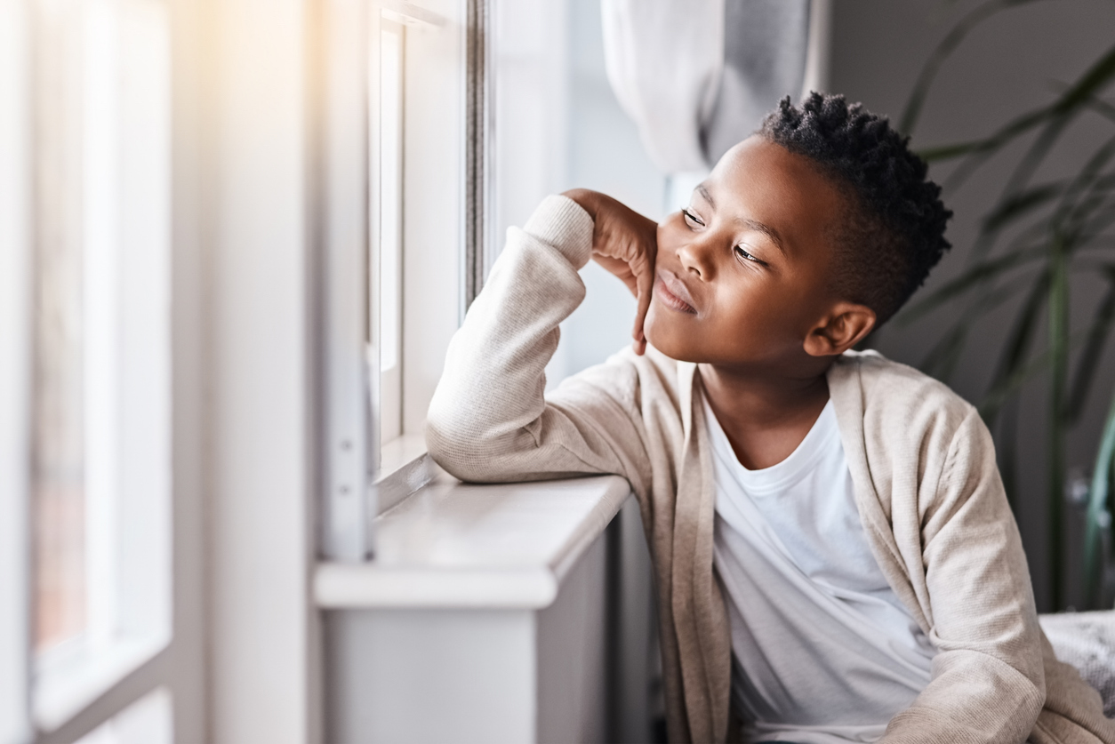 boy looking out a window