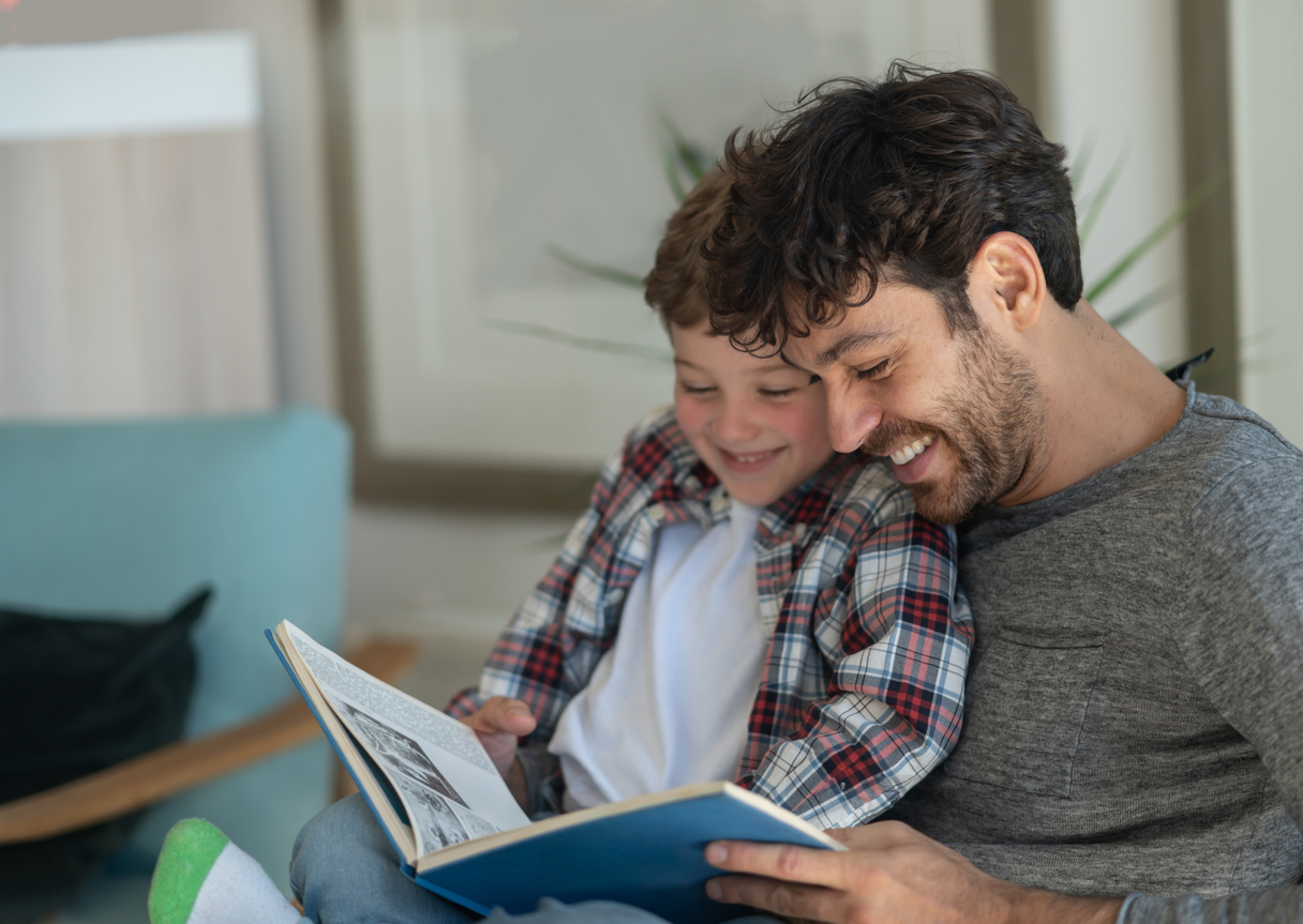 father and son reading a picture book together