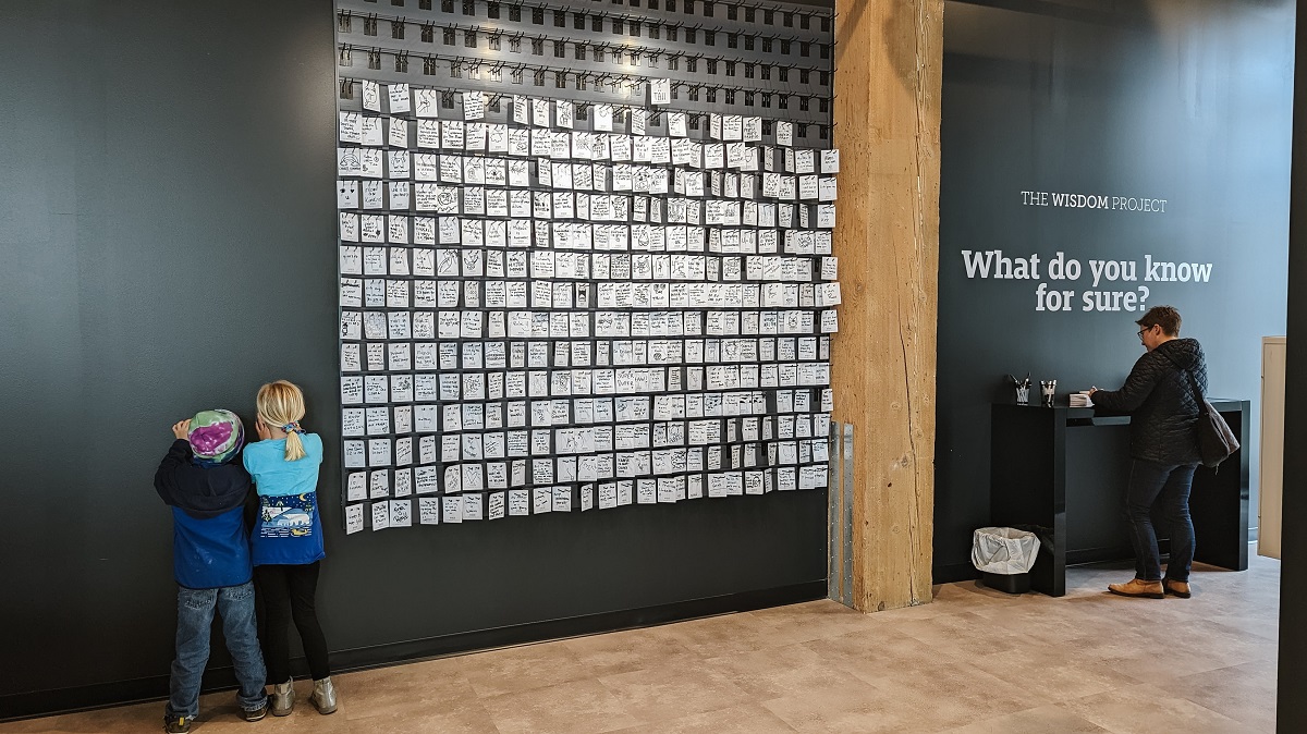 Kids at WNDR Seattle new interactive museum answer the entry prompt What do you know for sure? on post it notes