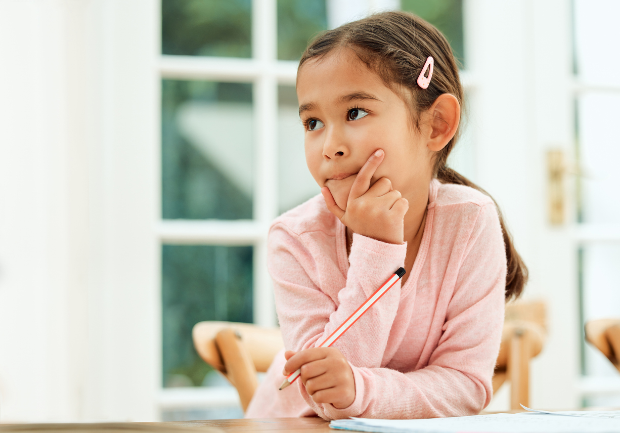 a thoughtful child looks to the side as she builds memory skills