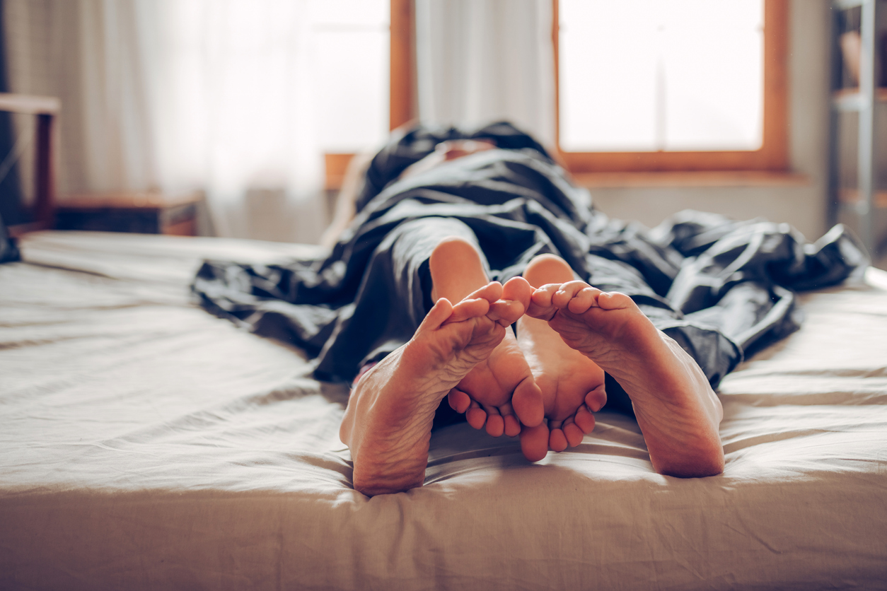 an adult couple being intimate in bed