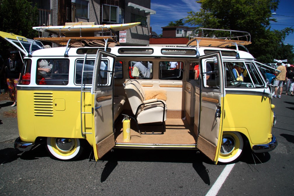 A yellow volkswagen bus is on display at the popular annual Greenwood Car Show among family activities in Seattle for summer