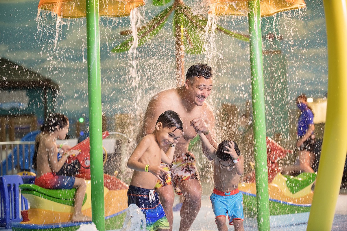 a dad plays with kids at Great Wolf Lodge