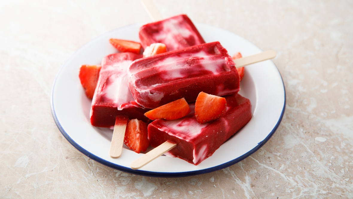 Strawberry and lemonade popsicles on a white plate are a great summertime treat