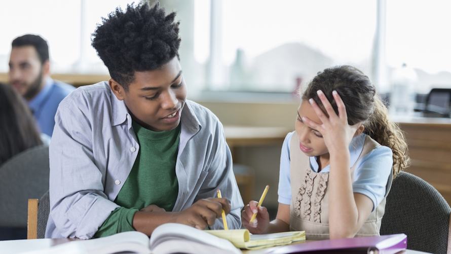 a teen tutors a younger child as part of a teen summer job