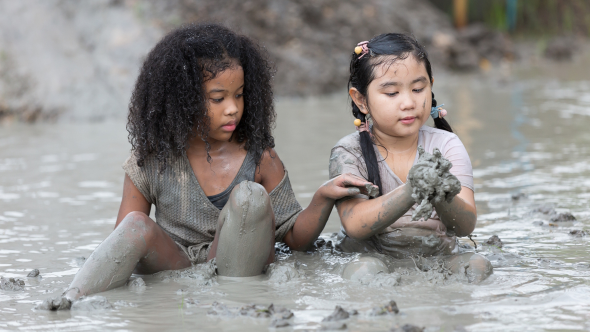 Collecting mud for mud paining messy outdoor art projects