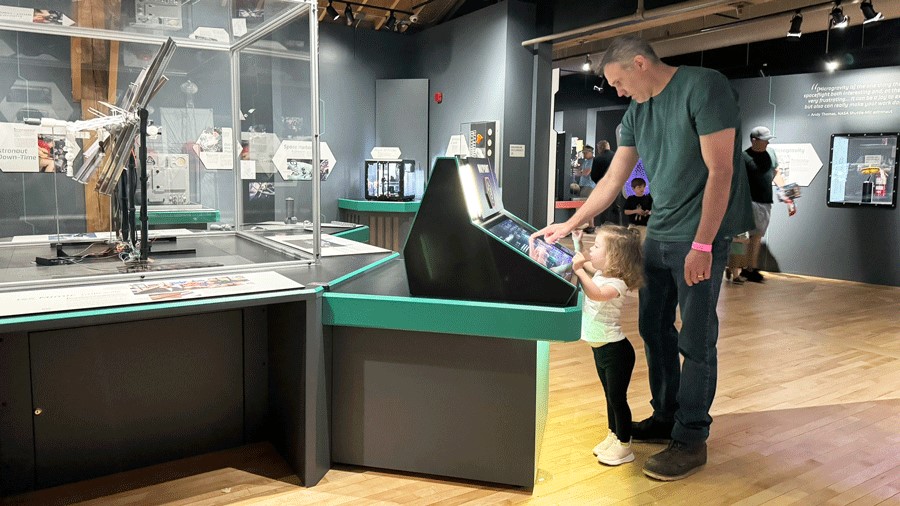 Family using the interactive elements of the Home Beyond Earth Exhibit at The Museum of Flight Seattle