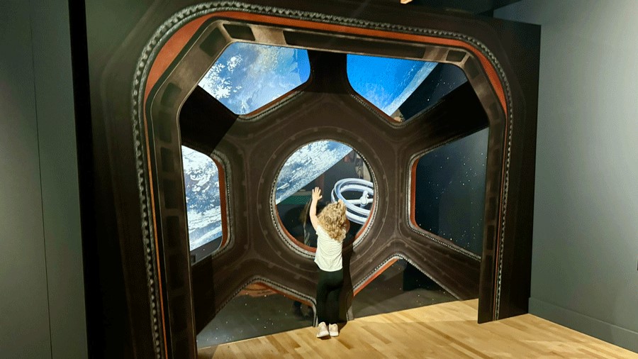 Young girl looks at a view of Earth from space at The Museum of Flight in Seattle