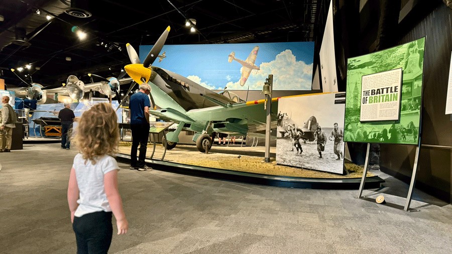 Young girl looking at fighter planes from World War II at The Museum of Flight in Seattle