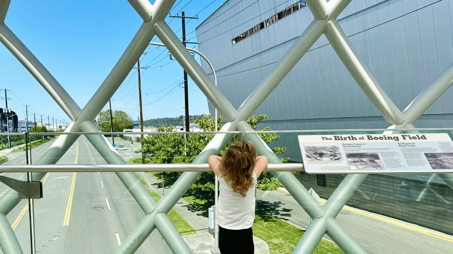 Young girl standing on the Memorial Bridge at The Museum of Flight in Seattle