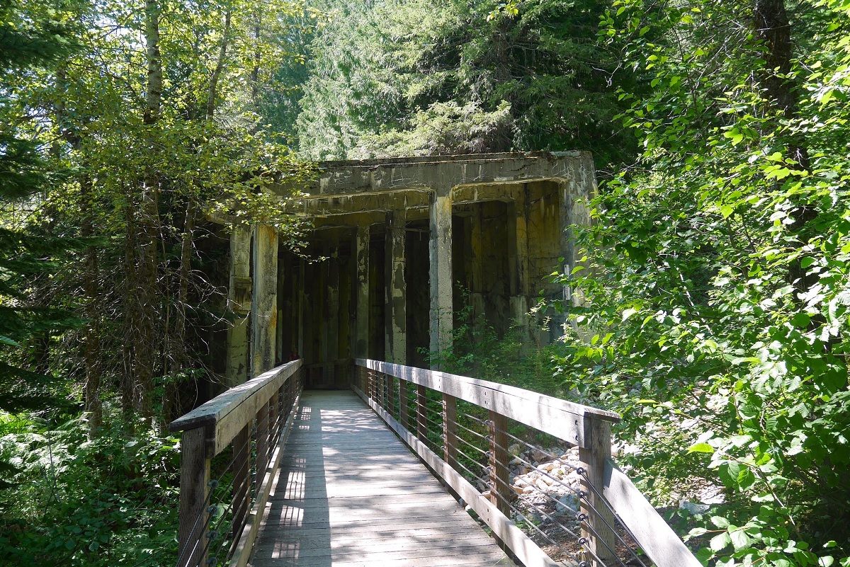 Ghost town hikes near Seattle include the Iron Goat Trail where the entrance to an abandoned mine shaft can be seen along the trail