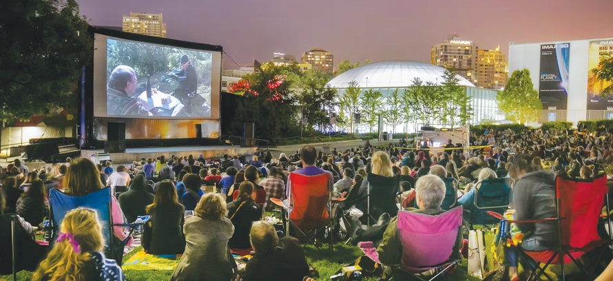 Large crowd of people watching an outdoor movie at the Seattle Center