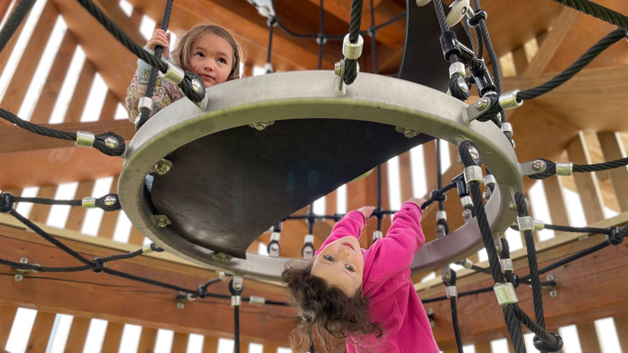 two girls in the tower at Melanie's Park in Tacoma