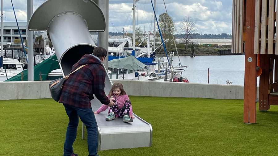 mom and daughter on a slide at Melanie's Park
