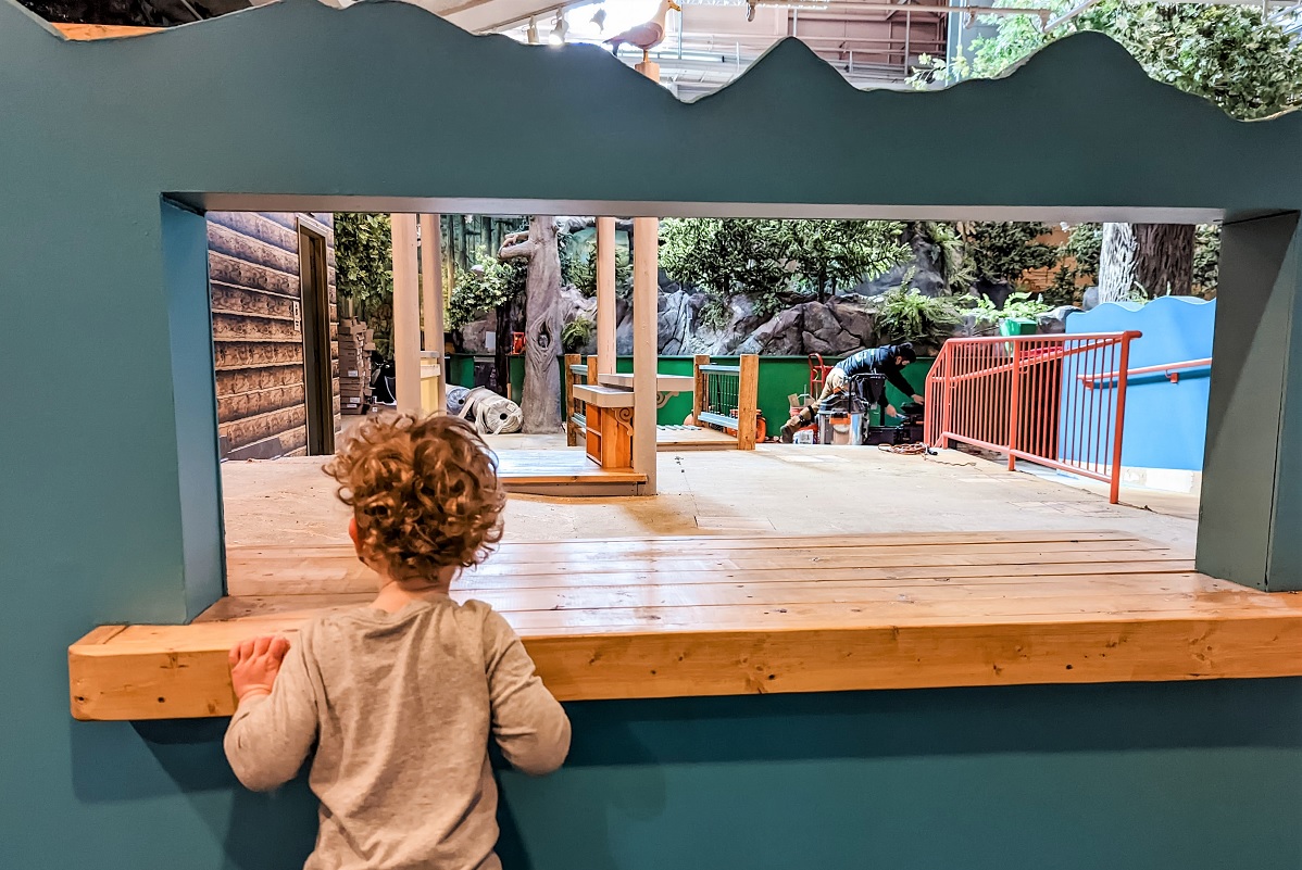 Young child surveys the updates getting installed in the revamped Seattle Children's Museum the day before its grand reopening