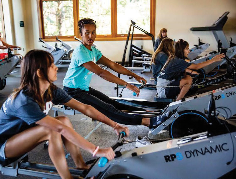 Two women working out with rowing machines