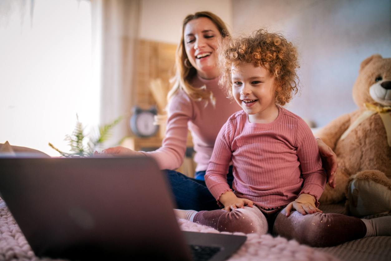 little girl and mom watch educational YouTube channels together