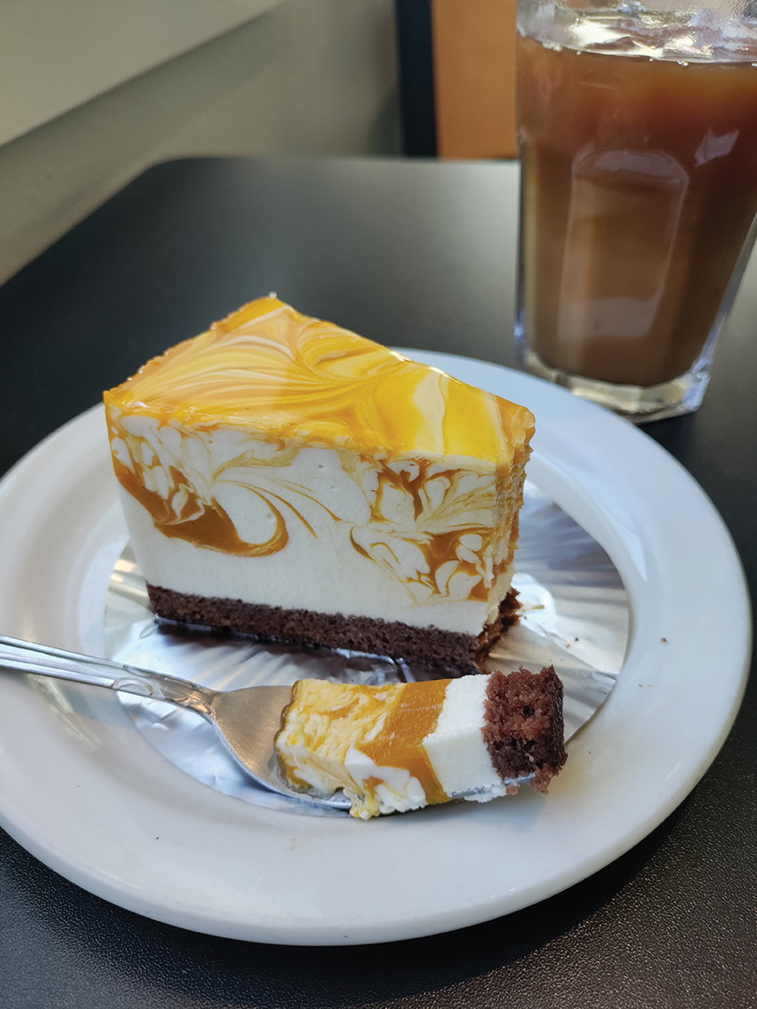 Cake slice with swirled top layer and chocolate on bottom