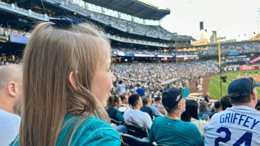 Young girl watches Seattle Mariners baseball game at T-Mobile Park.