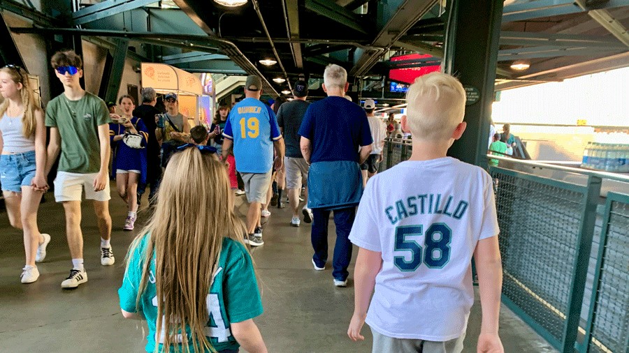 Two kids walking around T-Mobile Park during a Mariners Game